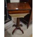 A Victorian mahogany sewing table on octagonal tapering column and quadraform supports with brass