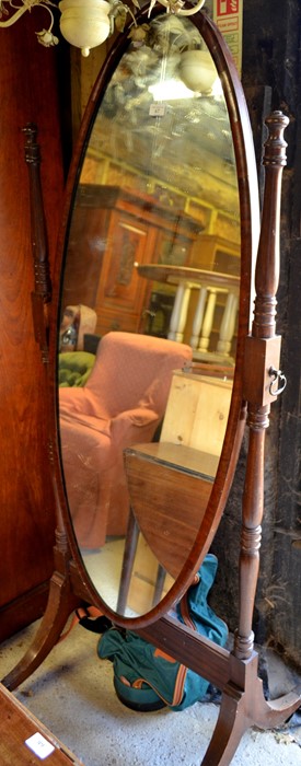 Mahogany framed oval cheval mirror on turned supports and splayed legs with brass caps and