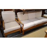 1970's teak conservatory suite comprising a three seater sofa and a two matching arm chairs