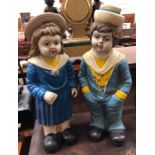 A companion pair of pottery figures a boy and a girl (2)