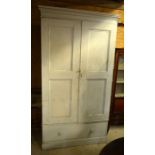Large antique painted pine cupboard with twin panelled doors enclosing shelves, over a single drawer