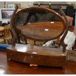 Victorian mahogany framed oval toilet mirror on bowfronte platform base with three drawers