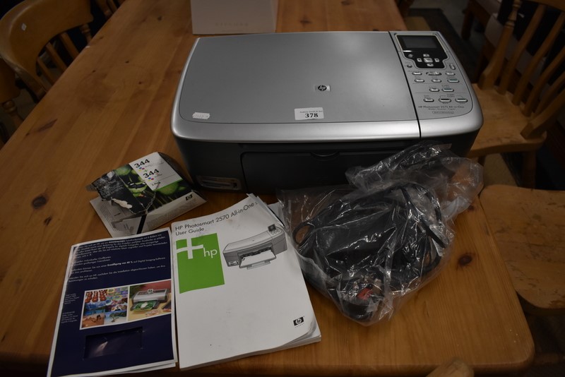 A Hewlett-Packard 2570 all-in-one series printer and assorted accessories
