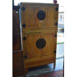 Early 20th century oriental tansu style two sectioned cabinet, the two pairs of metal bound cupboard