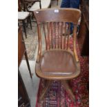 Early 20th century oak swivel chair with padded brown leather seat