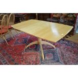 Ercol solid ash Windsor extending dining table with folding central leaf and shaped pedestal base