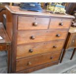 A late Victorian mahogany chest of two short over three long drawers with turned pulls