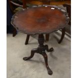 A mahogany scalloped tilt top occasional table on tri-form supports (a/f)