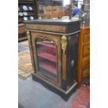 An 18th/19th century brass and ebonised pier cabinet with arched glazed panel door, raised on a