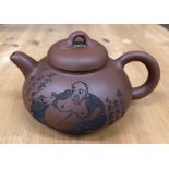 A Yixing teapot with domed cover, decorated with the Buddhist Monk, Budai beside a six-line