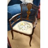 An Edwardian inlaid mahogany open arm chair with floral seat