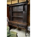 An 18th/19th century oak Shropshire dresser, the raised back with open shelves and shaped