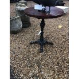 A Victorian style circular cast iron terrace table with wooden top