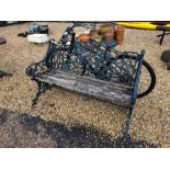 A cast iron Colebrookdale style garden bench with wood slat seat