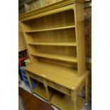 A contemporary light oak kitchen dresser with two drawers over a pot-board