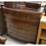A mahogany bowfront chest of two short over three long drawers raised on short turned supports