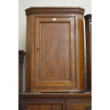 A 19th century mahogany and satin strung hanging corner cupboard with single panelled door