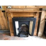 A Victorian style cast iron tile inset fire inset with stripped pine surround to/with companion set