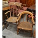 Elm seated spindle back armchair with turned supports to/w a cane seated low armchair (2)