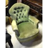 Victorian low armchair with green button back dralon upholstery raised on turned front legs with