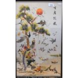 A Chinese textile picture woven with cranes and other birds beside a large pine tree; framed and