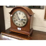 A mahogany twin-train mantel clock with silvered dial