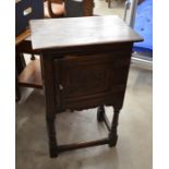 Carved oak pot cupboard with panelled door, turned supports and stretchers