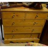 Stained pine chest of two short over three long drawers raised on bracket feet united by a wavy