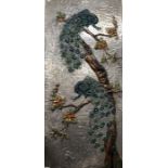 A hammered white metal and polychrome enamelled panel featuring peacocks on a flowering branch