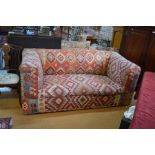 A two seater chesterfield style sofa with geometric design kelim upholstery 192cm wide x 93cm deep x