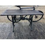 A cast iron Colebrookdale style plank top garden table