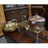 A pierced brass rectangular trivet, an antique copper kettle and a large circular riveted copper and
