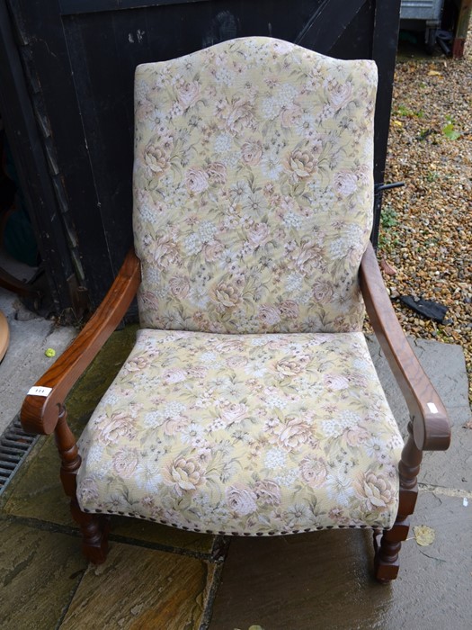 An Old Charm oak armchair with floral upholstery, turned supports with stretchers