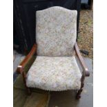 An Old Charm oak armchair with floral upholstery, turned supports with stretchers