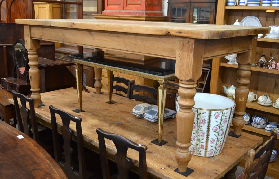 A waxed pine kitchen dining table, rectangular top raised on turned supports