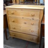 A stripped pine chest of four long drawers with turned pulls and short turned supports