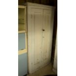 Antique painted pine hall cupboard with full length panelled doors enclosing a shelved interior