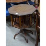 An octagonal mahogany revolving bookcase on turned column and quadraform supports