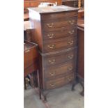 A mahogany bow front tall boy chest with six drawers, raised on shell carved cabriole supports