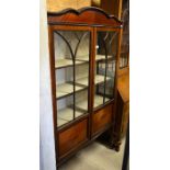 Edwardian inlaid mahogany display cabinet with glazed and panelled doors enclosing three shelves