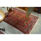 Turkman red ground rug with repeating gul design 135x100cm