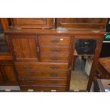 Edwardian mahogany compactum fitted with seven drawers, a small panelled cupboard and mirrored