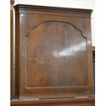 A mahogany hanging corner cupboard with single panelled door