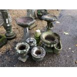 A selection of assorted cast stone garden items including two birdbaths, marble urns, a small trough