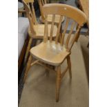 Set of eight beech dining chairs raised on turned supports with stretchers