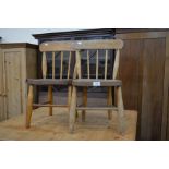 A pair of early 20th century church children's chairs, spindle back with elm seats