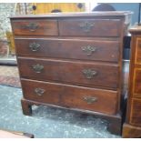 A George III mahogany chest of two short over three long graduated drawers, raised on shaped bracket