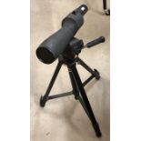 A Prisma Bushnell Spacemaster telescope on tripod base