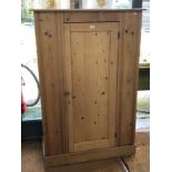 A Victorian stripped and waxed pine single door cupboard, the interior fitted with shelves