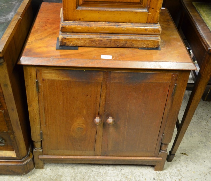 A mahogany media cabinet with a pair of panelled cupboard doors